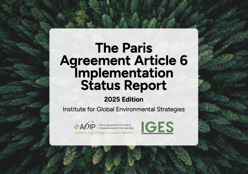Cover of the The Paris Agreement Article 6 Implementation Status Report 2025 Edition with evergreen trees.